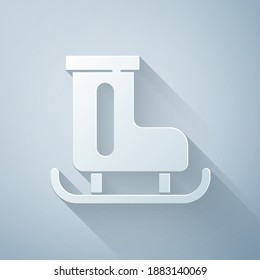 Paper cut Figure skates icon isolated on grey background. Ice skate shoes icon. Sport boots with blades. Paper art style. Vector