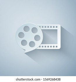 Paper cut Film reel and play video movie film icon isolated on grey background. Paper art style. Vector Illustration