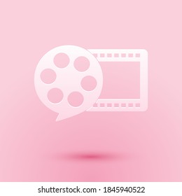 Paper cut Film reel and play video movie film icon isolated on pink background. Paper art style. Vector.