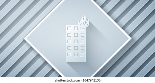 Paper cut Fire in burning building on city street icon isolated on grey background. Paper art style. Vector Illustration