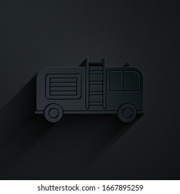 Paper cut Fire truck icon isolated on black background. Fire engine. Firefighters emergency vehicle. Paper art style. Vector Illustration