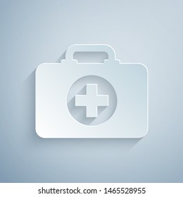 Paper cut First aid kit icon isolated on grey background. Medical box with cross. Medical equipment for emergency. Healthcare concept. Paper art style. Vector Illustration