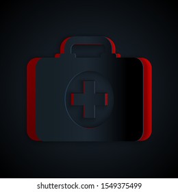 Paper cut First aid kit icon isolated on black background. Medical box with cross. Medical equipment for emergency. Healthcare concept. Paper art style. Vector Illustration