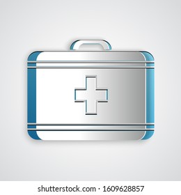 Paper cut First aid kit icon isolated on grey background. Medical box with cross. Medical equipment for emergency. Healthcare concept. Paper art style. Vector Illustration
