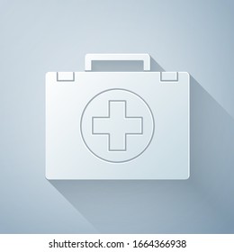 Paper cut First aid kit icon isolated on grey background. Medical box with cross. Medical equipment for emergency. Healthcare concept. Paper art style. Vector Illustration