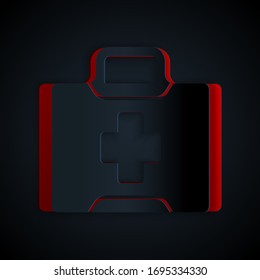 Paper cut First aid kit icon isolated on black background. Medical box with cross. Medical equipment for emergency. Healthcare concept. Paper art style. Vector Illustration