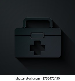 Paper cut First aid kit icon isolated on black background. Medical box with cross. Medical equipment for emergency. Healthcare concept. Paper art style. Vector Illustration