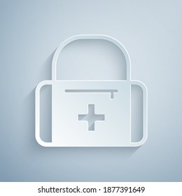 Paper cut First aid kit icon isolated on grey background. Medical box with cross. Medical equipment for emergency. Healthcare concept. Paper art style. Vector.