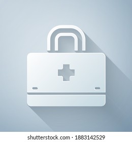 Paper cut First aid kit icon isolated on grey background. Medical box with cross. Medical equipment for emergency. Healthcare concept. Paper art style. Vector