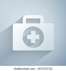 Paper cut First aid kit icon isolated on grey background. Medical box with cross. Medical equipment for emergency. Healthcare concept. Paper art style. Vector
