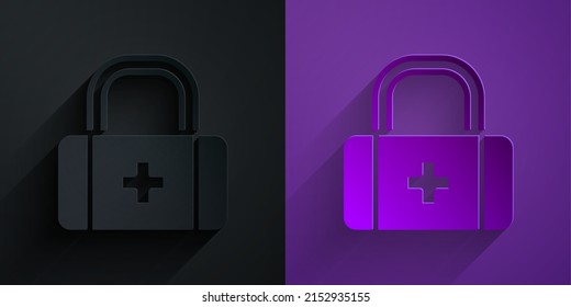 Paper cut First aid kit icon isolated on black on purple background. Medical box with cross. Medical equipment for emergency. Healthcare concept. Paper art style. Vector