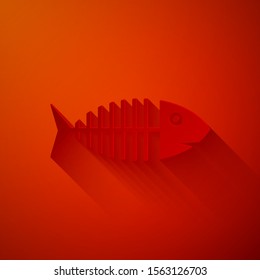 Paper cut Fish skeleton icon isolated on red background. Fish bone sign. Paper art style. Vector Illustration