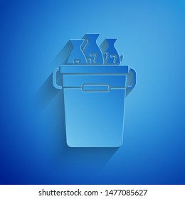 Paper cut Fishing bucket with fishes icon isolated on blue background. Fish in a bucket. Paper art style. Vector Illustration