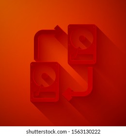 Paper cut A fixed data storage device hard disk with arrows, data copy icon isolated on red background. Data exchange with hard disk drive. Paper art style. Vector Illustration
