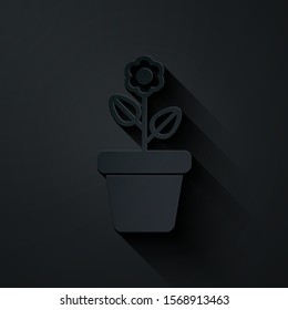 Paper cut Flower in pot icon isolated on black background. Plant growing in a pot. Potted plant sign. Paper art style. Vector Illustration