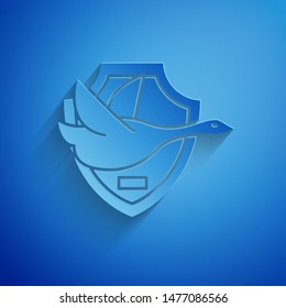 Paper cut Flying duck on shield icon isolated on blue background. Hunting trophy on wall. Paper art style. Vector Illustration