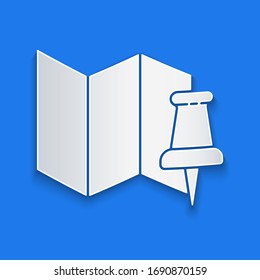 Paper cut Folded map with push pin icon isolated on blue background. Paper art style. Vector Illustration