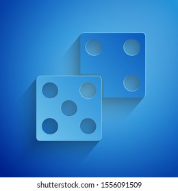 Paper cut Game dice icon isolated on blue background. Casino gambling. Paper art style. Vector Illustration