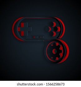 Paper cut Gamepad and gear icon isolated on black background. Adjusting app, service concept, setting options, maintenance, repair, fixing. Paper art style. Vector Illustration