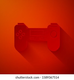 Paper cut Gamepad icon isolated on red background. Game controller. Paper art style. Vector Illustration