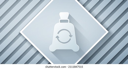 Paper cut Garbage bag with recycle symbol icon isolated on grey background. Trash can icon. Recycle basket sign. Paper art style. Vector