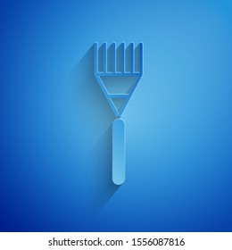 Paper cut Garden rake icon isolated on blue background. Tool for horticulture, agriculture, farming. Ground cultivator. Housekeeping equipment. Paper art style. Vector Illustration
