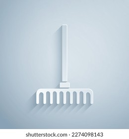 Paper cut Garden rake icon isolated on grey background. Tool for horticulture, agriculture, farming. Ground cultivator. Paper art style. Vector