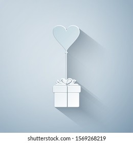 Paper cut Gift with balloon in shape of heart icon isolated on grey background. Valentine's day, wedding, birthday card. Paper art style. Vector Illustration