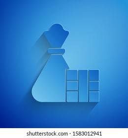 Paper cut Gift box and bag icon isolated on blue background. Merry Christmas and Happy New Year. Paper art style. Vector Illustration