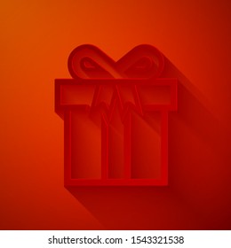 Paper cut Gift box icon isolated on red background. Paper art style. Vector Illustration