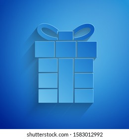 Paper cut Gift box icon isolated on blue background. Merry Christmas and Happy New Year. Paper art style. Vector Illustration