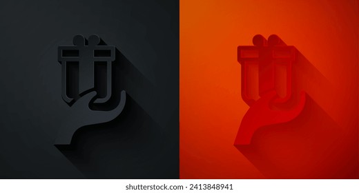 Paper cut Give gift icon isolated on black and red background. Gift in hand. The concept of giving and receiving a gift. Paper art style. Vector