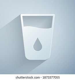 Paper cut Glass with water icon isolated on grey background. Soda glass. Paper art style. Vector