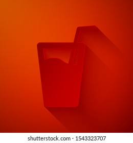 Paper cut Glass with water and tube for drinking icon isolated on red background. Soda glass. Paper art style. Vector Illustration