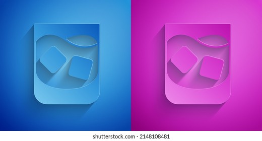 Paper cut Glass of whiskey and ice cubes icon isolated on blue and purple background. Paper art style. Vector