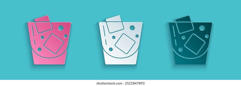 Paper cut Glass of whiskey and ice cubes icon isolated on blue background. Paper art style. Vector