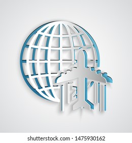 Paper cut Globe with flying plane icon isolated on grey background. Airplane fly around the planet earth. Aircraft world icon. Paper art style. Vector Illustration