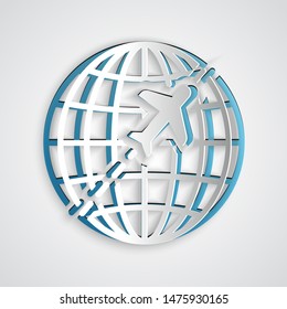 Paper cut Globe with flying plane icon isolated on grey background. Airplane fly around the planet earth. Aircraft world icon. Paper art style. Vector Illustration