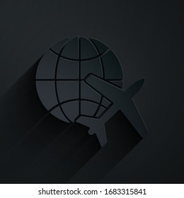 Paper cut Globe with flying plane icon isolated on black background. Airplane fly around the planet earth. Aircraft world icon. Paper art style. Vector Illustration