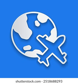 Paper cut Globe with flying plane icon isolated on blue background. Airplane fly around the planet earth. Aircraft world icon. Paper art style. Vector