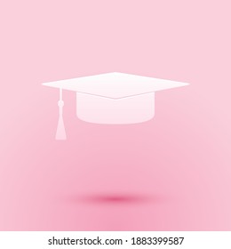 Paper cut Graduation cap icon isolated on pink background. Graduation hat with tassel icon. Paper art style. Vector.