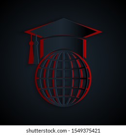 Paper cut Graduation cap on globe icon isolated on black background. World education symbol. Online learning or e-learning concept. Paper art style. Vector Illustration
