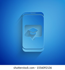 Paper cut Graduation cap on screen smartphone icon isolated on blue background. Online learning or e-learning concept. Paper art style. Vector Illustration