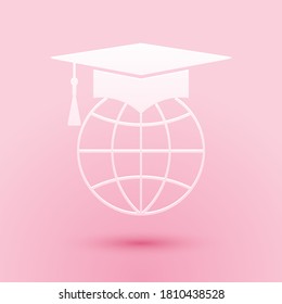 Paper cut Graduation cap on globe icon isolated on pink background. World education symbol. Online learning or e-learning concept. Paper art style. Vector.