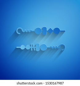 Paper cut Grilled shish kebab on skewer stick icon isolated on blue background. Meat kebab on skewer stick. Picnic with grilled meat. Paper art style. Vector Illustration