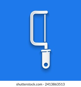 Paper cut Hacksaw icon isolated on blue background. Metal saw for wood and metal. Paper art style. Vector Illustration