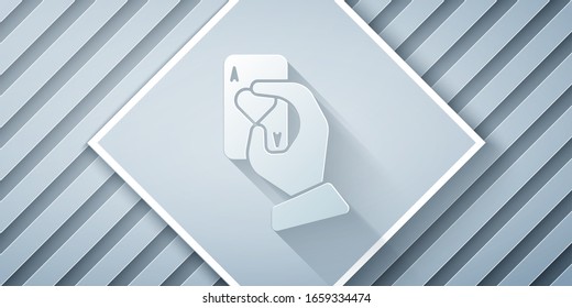 Paper cut Hand holding playing cards icon isolated on grey background. Casino game design. Paper art style. Vector Illustration