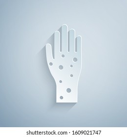 Paper cut Hand with psoriasis or eczema icon isolated on grey background. Concept of human skin response to allergen or chronic body problem. Paper art style. Vector Illustration