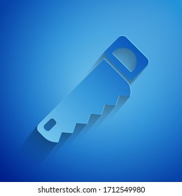 Paper cut Hand saw icon isolated on blue background. Paper art style. Vector Illustration