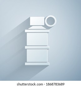 Paper cut Hand smoke grenade icon isolated on grey background. Bomb explosion. Paper art style. Vector